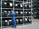 Man putting Volkswagen tyres on the rack