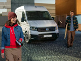 Man and woman leaving their Volkswagen Crafter parked behind them