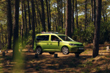 Volkswagen Caddy Cargo driving through woods